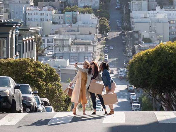 girls taking selfy in the street