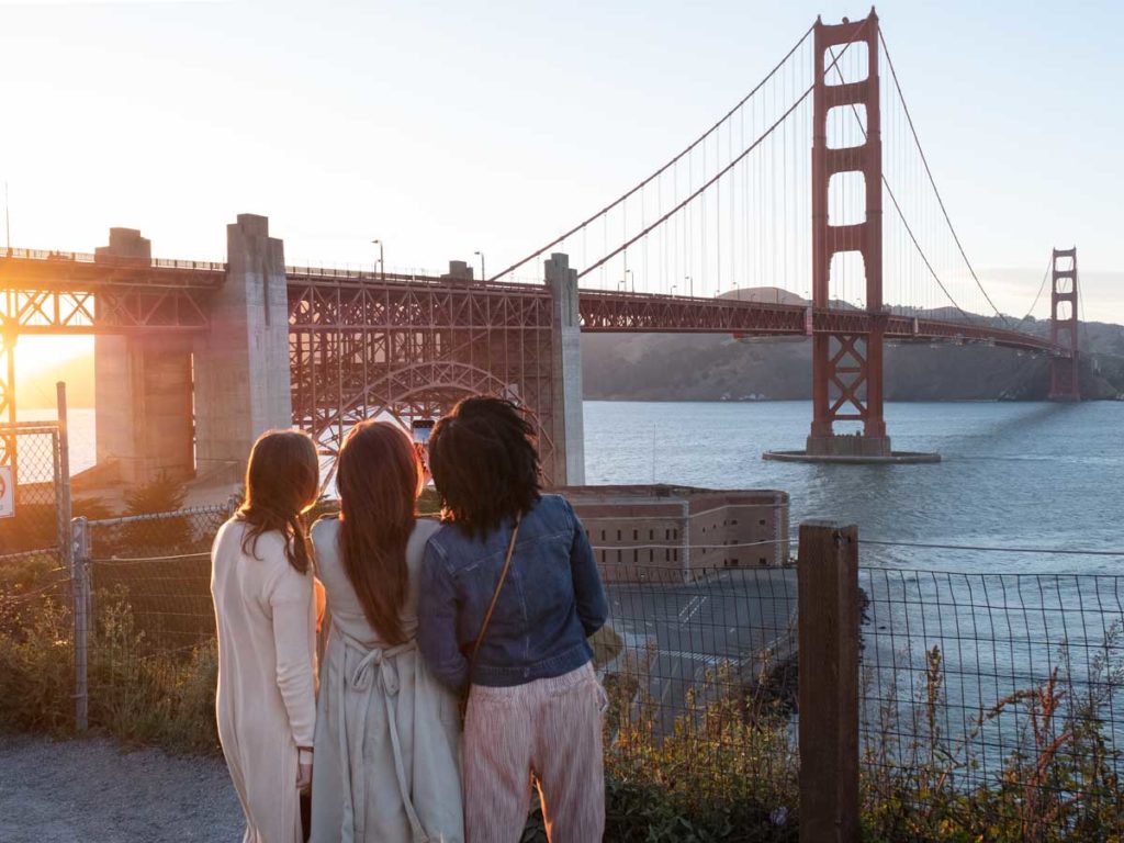 Girls looking at the Golden Gate Bridge.