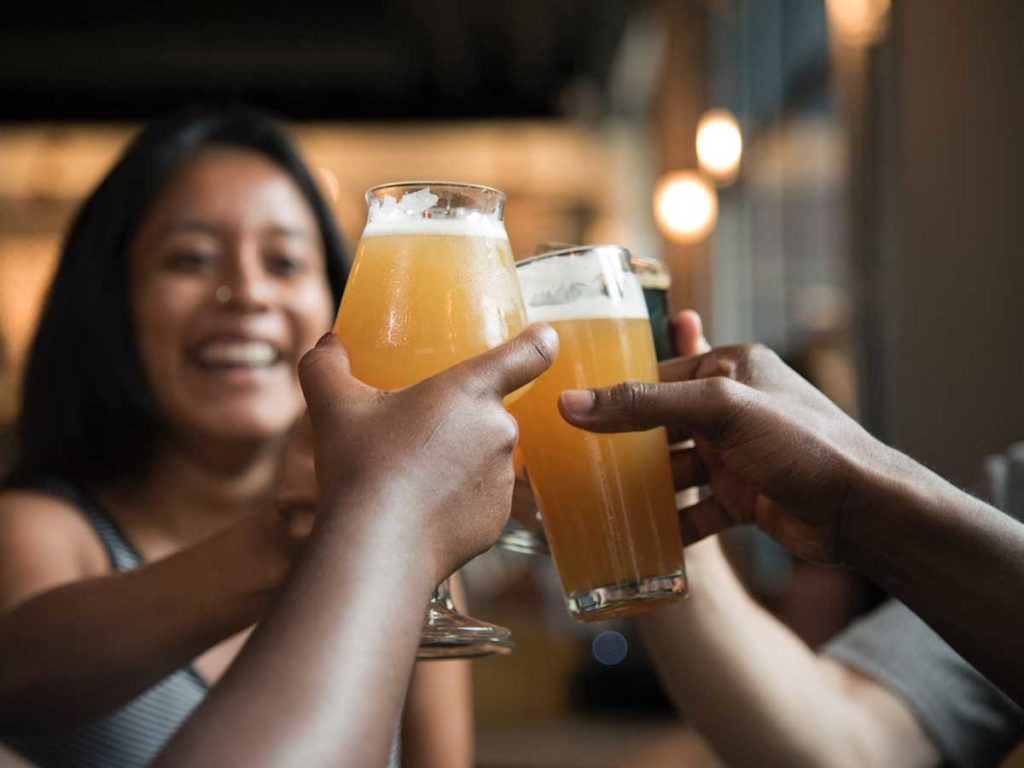 people cheering with beers