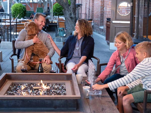 Family with dog outside the hotel with Fire Pit