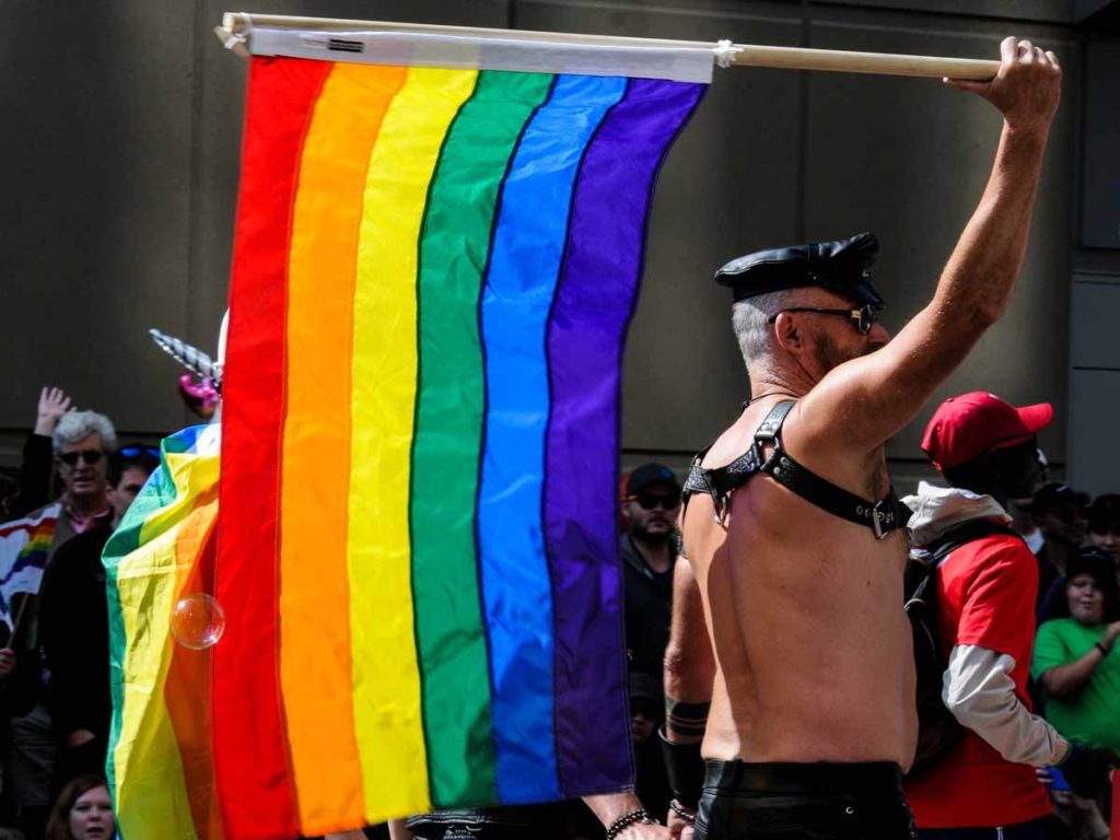 man with gay parade flag