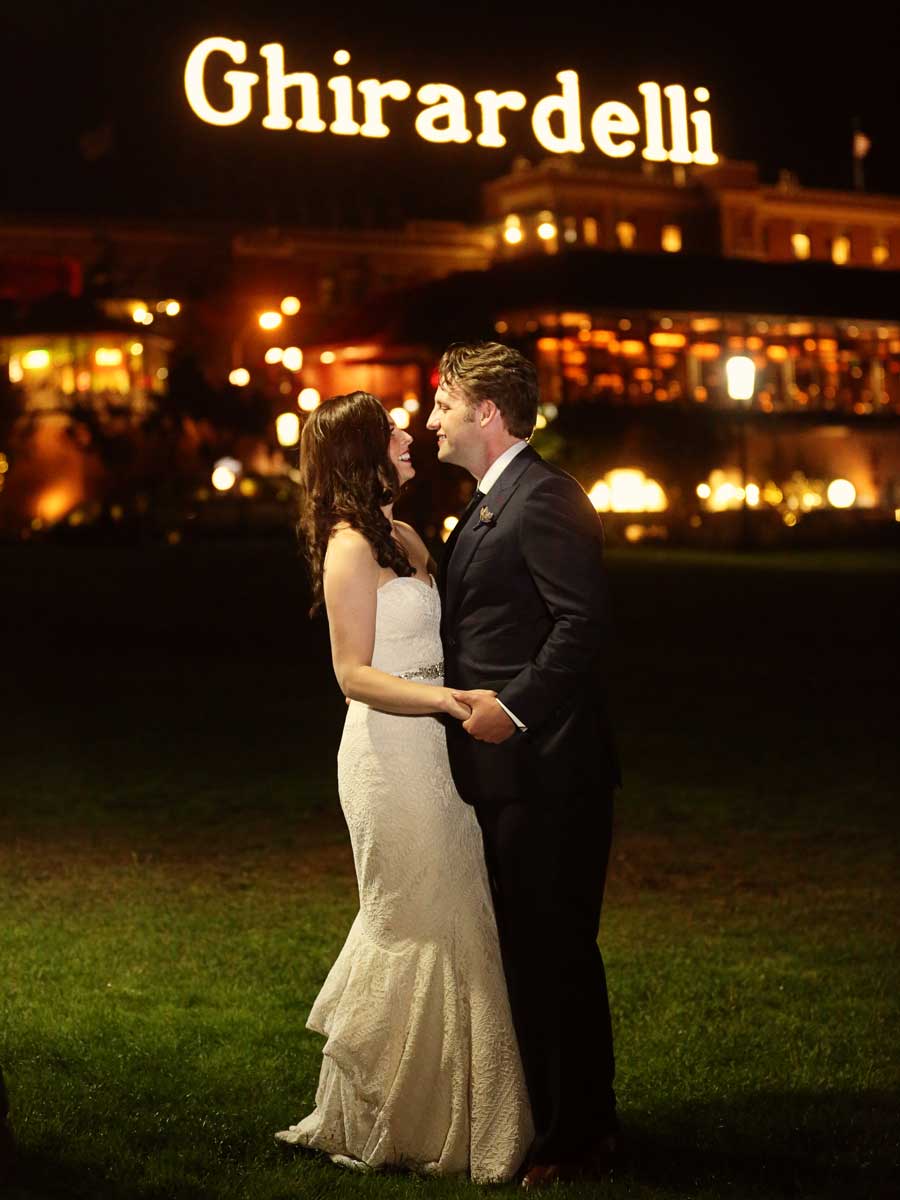 Bride And Groom In Front Of Ghirardelli Sign.