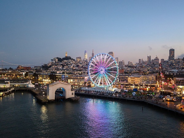 Skystar observation wheel glowing at twilight over Fisherman's Wharf near the Argonaut Hotel in San Francisco