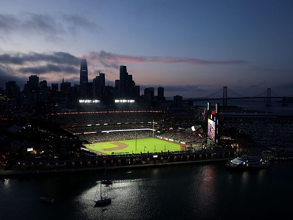 Oracle Park ballpark and the San Francisco skyline at dusk, a short trip from the Argonaut Hotel in San Francisco