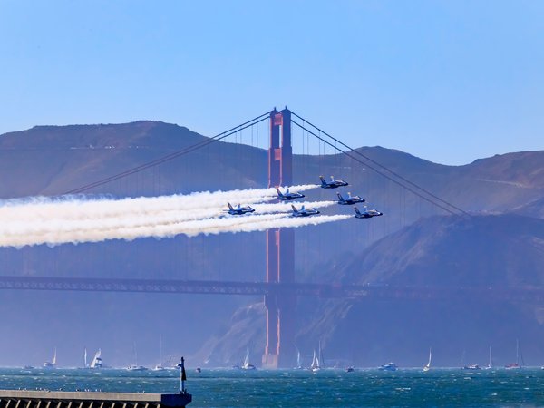 Blue Angels flying past the Golden Gate Bridge during Fleet Week, near the Argonaut Hotel at Fisherman's Wharf, San Francisco